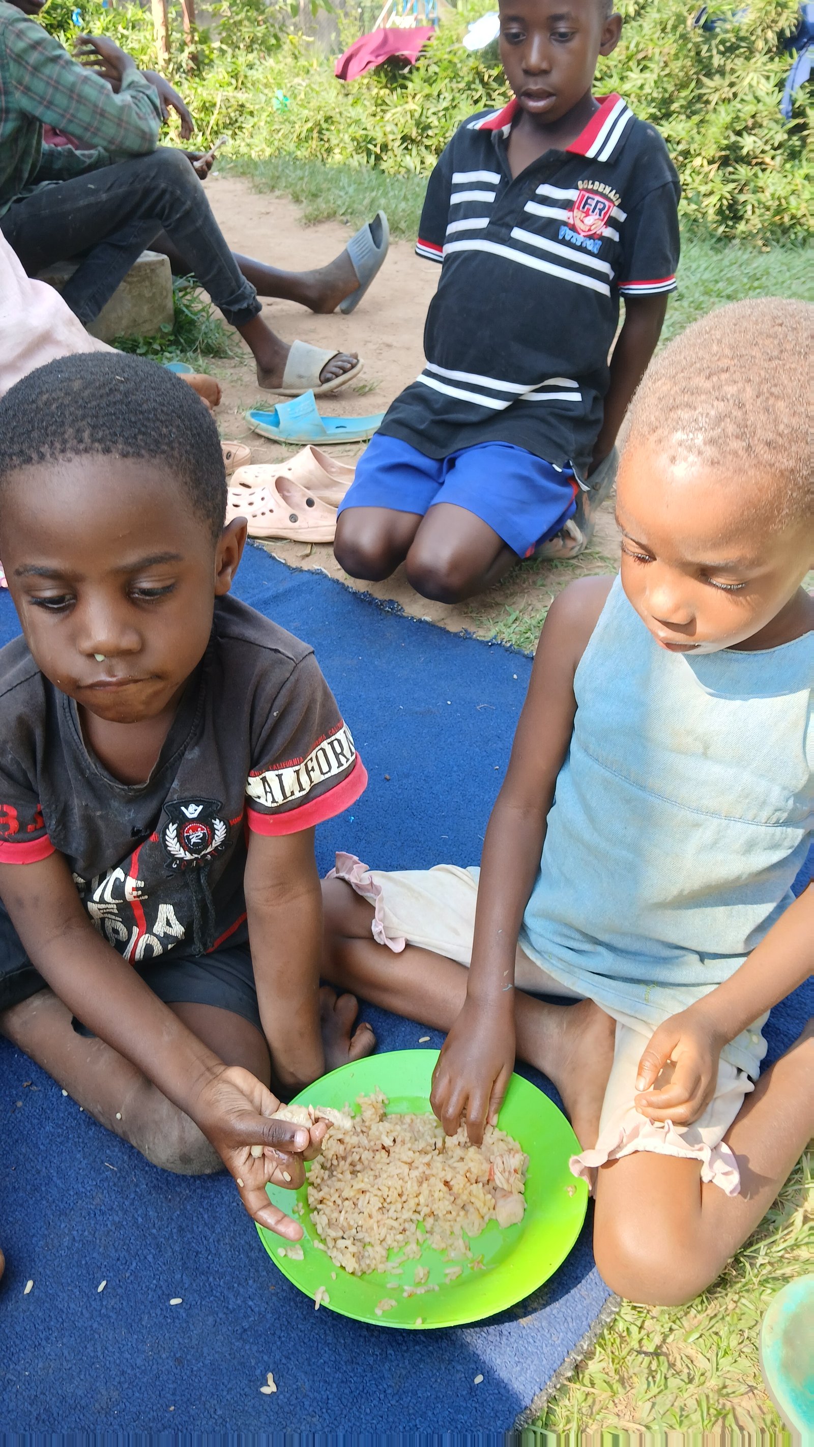 Children eating together outdoors