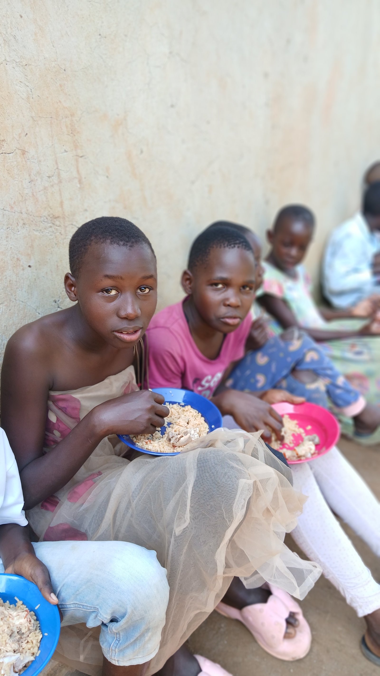 Children sitting side by side with their food