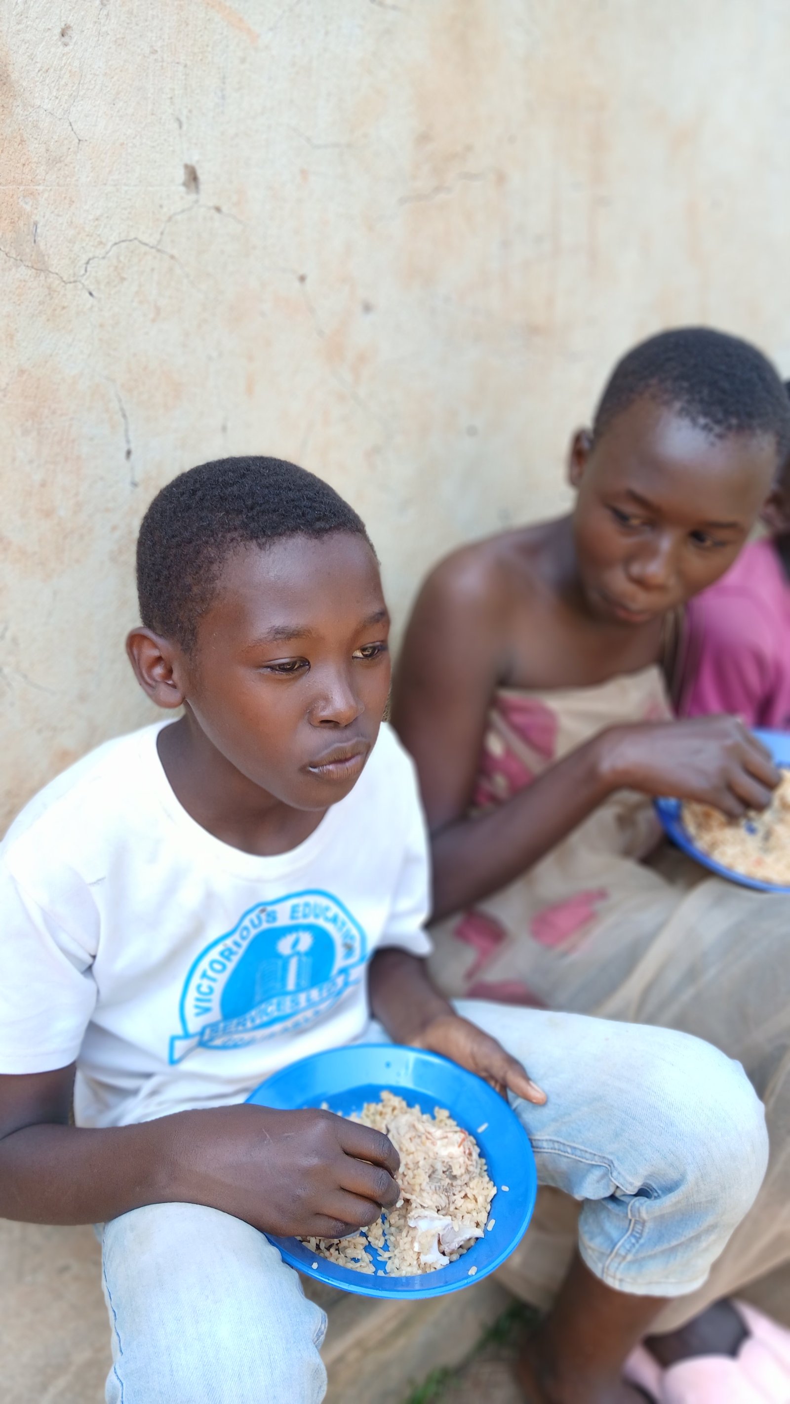 A child holding a bowl of food